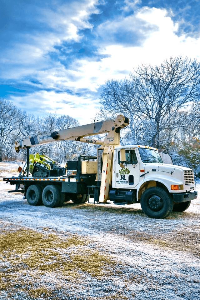 Crane truck staged in snowy conditions during an ice storm safety post